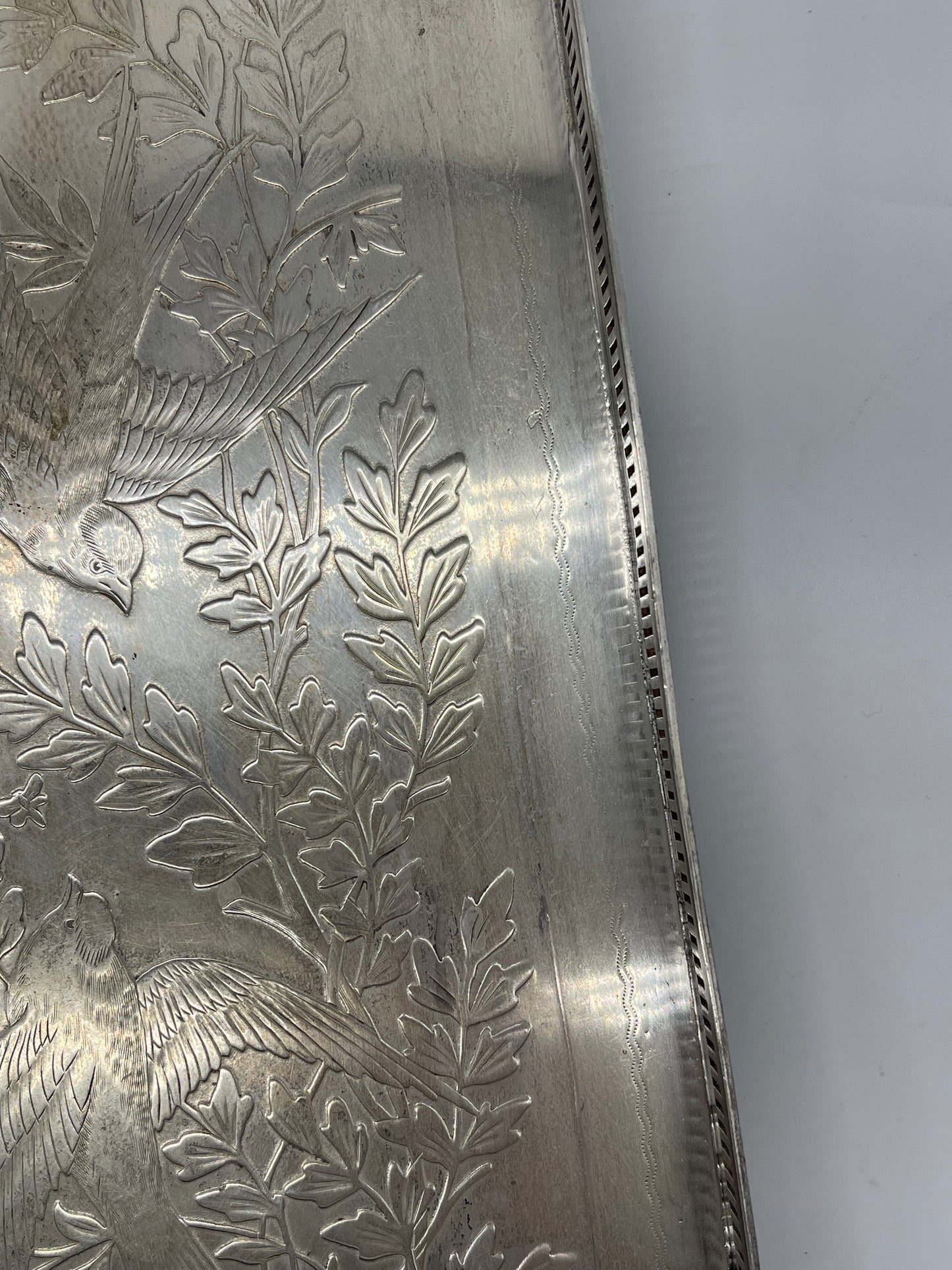 Exceptional footed silver tray with wooden serving handles and bird and floral engraving scene