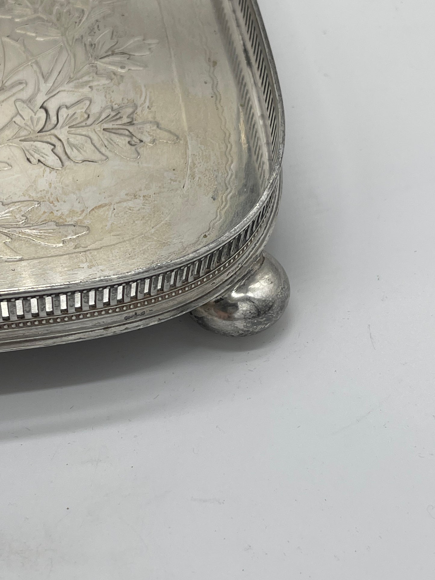 Exceptional footed silver tray with wooden serving handles and bird and floral engraving scene