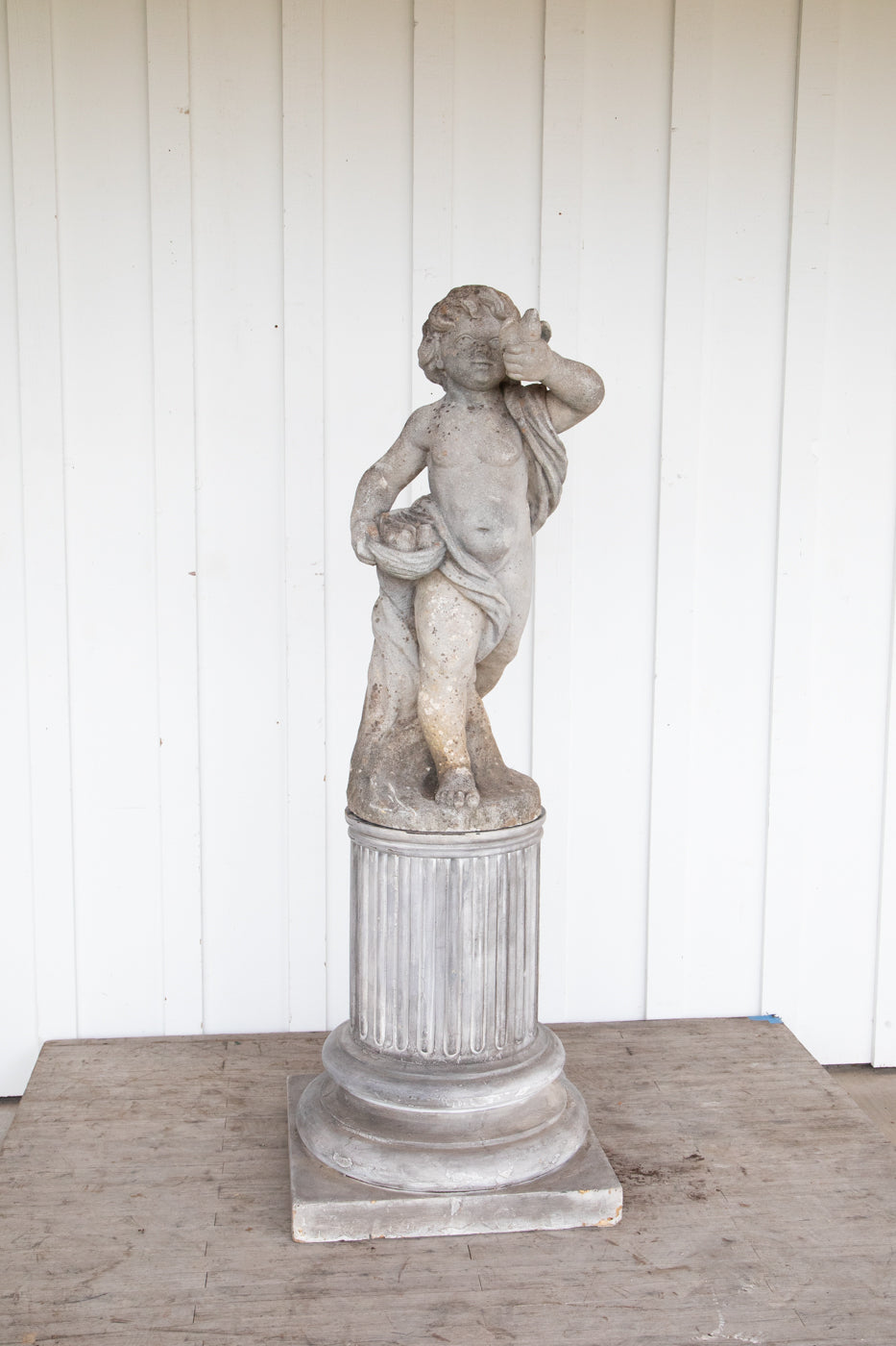 Concrete Cherub on wooden plinth